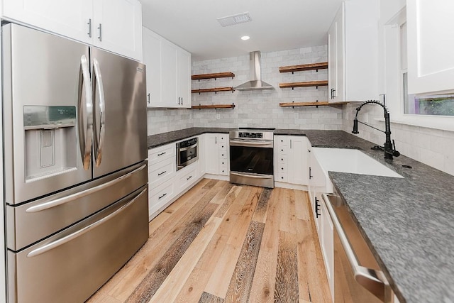188 W Kaanapali Ln, Bastrop, TX 78602 - kitchen featuring appliances with stainless steel finishes, wall chimney exhaust hood, open shelves, backsplash, and white cabinetry