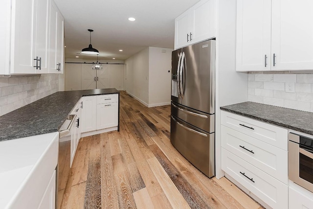 188 W Kaanapali Ln, Bastrop, TX 78602 - kitchen with appliances with stainless steel finishes, white cabinets, light wood-type flooring, backsplash, and recessed lighting