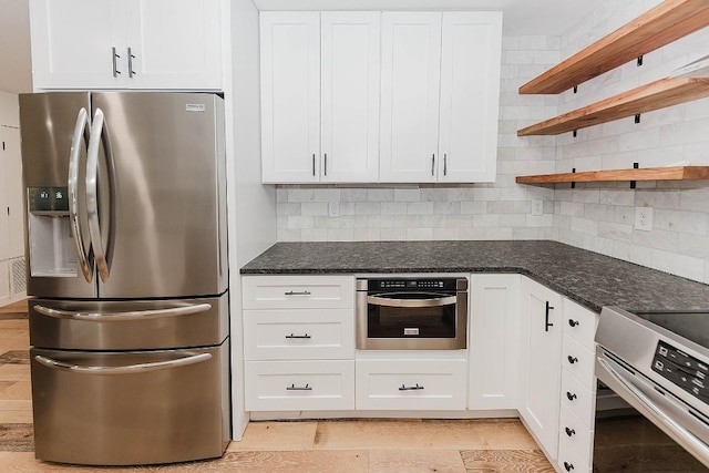 188 W Kaanapali Ln, Bastrop, TX 78602 - kitchen with stainless steel appliances, open shelves, white cabinetry, and decorative backsplash