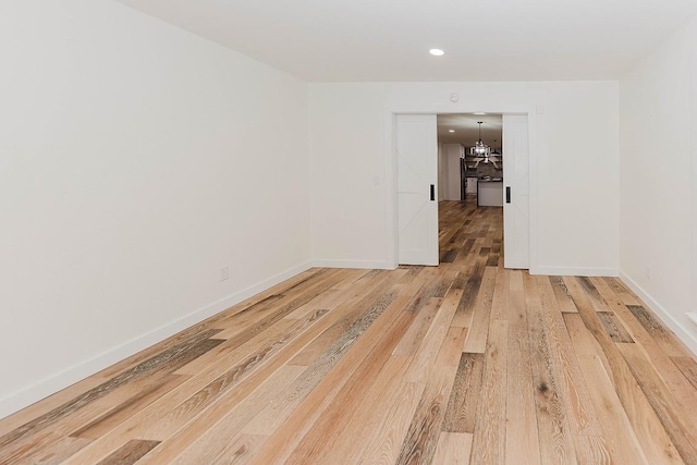 188 W Kaanapali Ln, Bastrop, TX 78602 - empty room featuring light wood-type flooring, recessed lighting, baseboards, and a chandelier