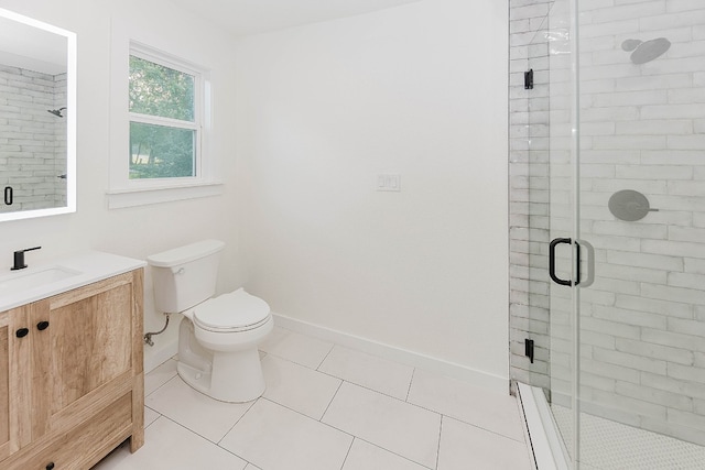 bathroom featuring tile patterned floors, toilet, an enclosed shower, and vanity