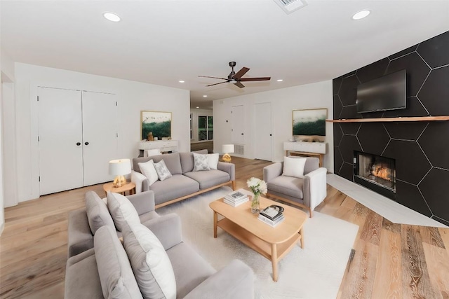 188 W Kaanapali Ln, Bastrop, TX 78602 - living room with light wood-type flooring, recessed lighting, a ceiling fan, and a large fireplace