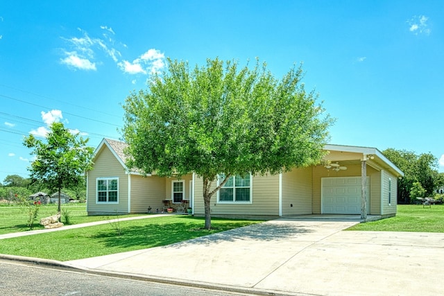 view of property hidden behind natural elements with a garage and a front lawn