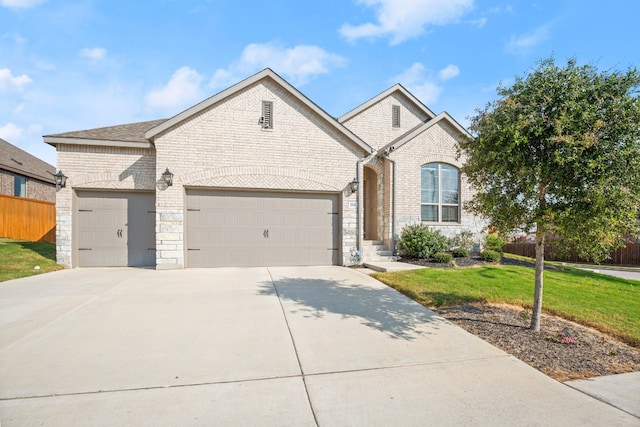 view of front of house featuring a garage and a front yard