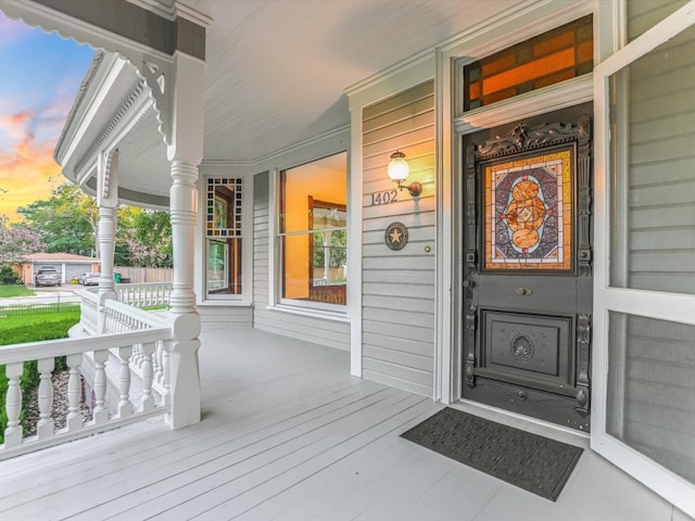 exterior entry at dusk with a porch