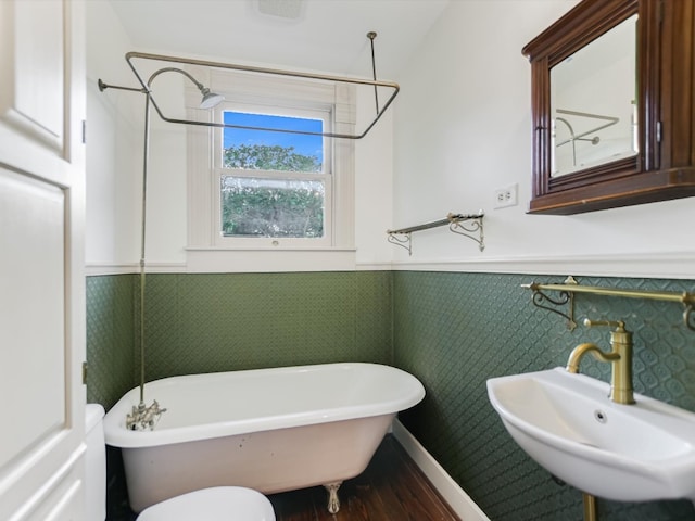 bathroom featuring sink, toilet, and wood-type flooring