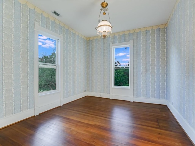 1402 Church St, Bastrop, TX 78602 - empty room featuring hardwood / wood-style flooring, a chandelier, and wallpapered walls
