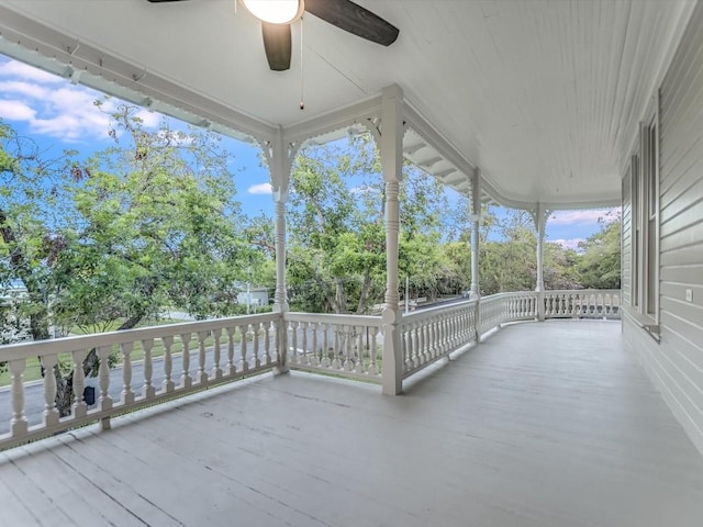 wooden deck featuring ceiling fan