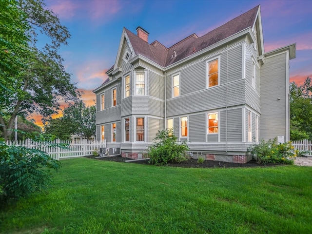 back house at dusk with a yard