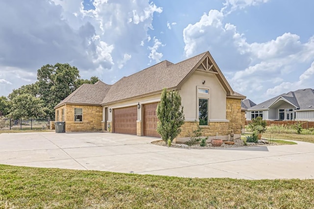 100 Gabgrove Ct, Georgetown, TX 78633 - view of front of property with stone siding, driveway, an attached garage, stucco siding, and roof with shingles