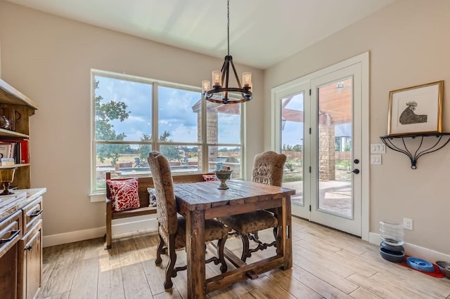 100 Gabgrove Ct, Georgetown, TX 78633 - dining space with a chandelier and light wood finished floors