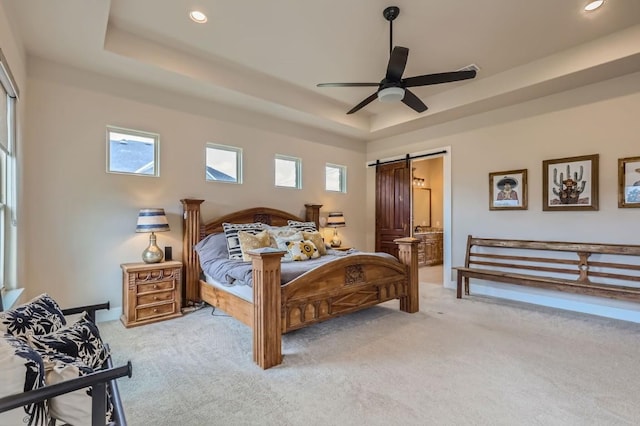 100 Gabgrove Ct, Georgetown, TX 78633 - bedroom with light colored carpet, a tray ceiling, a barn door, recessed lighting, and ceiling fan