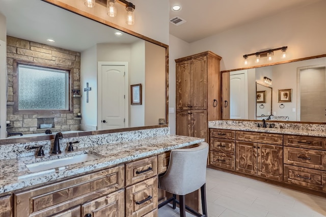 bathroom featuring tile patterned flooring and vanity