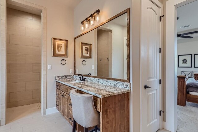 bathroom featuring ceiling fan, vanity, and tile patterned floors