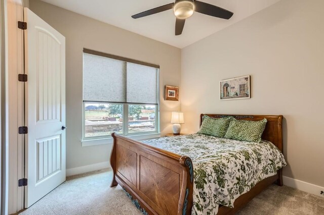 bedroom featuring ceiling fan and light carpet