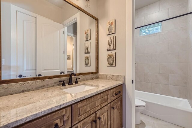 full bathroom with tiled shower / bath combo, tile patterned flooring, toilet, and vanity