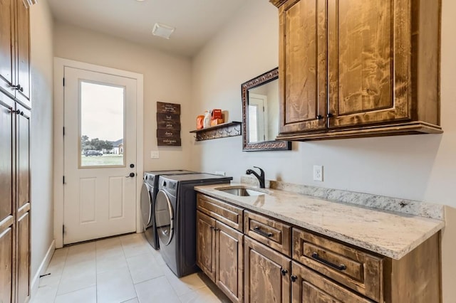 100 Gabgrove Ct, Georgetown, TX 78633 - washroom featuring cabinet space, washing machine and dryer, and light tile patterned floors