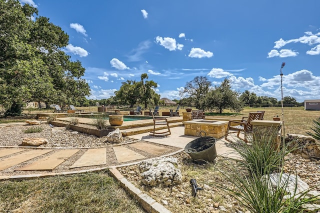 exterior space featuring a patio and a fire pit