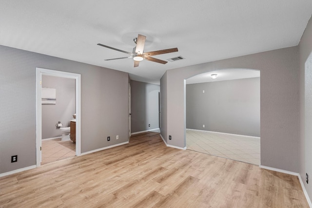 tiled empty room with ceiling fan