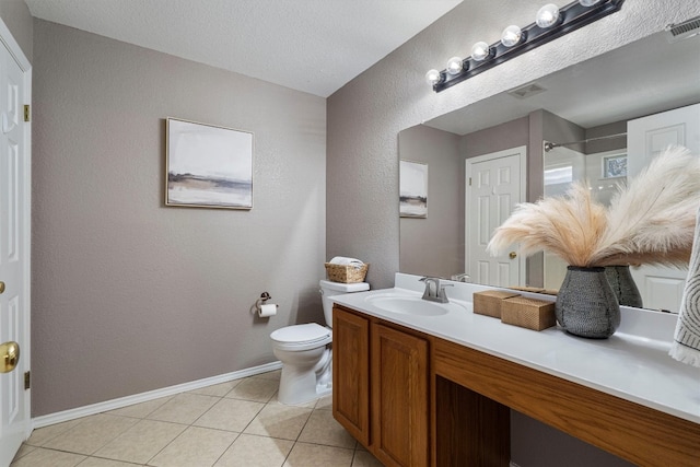 bathroom featuring tile patterned flooring, toilet, a textured ceiling, and vanity