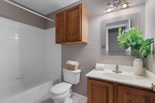 full bathroom featuring tile patterned flooring, toilet, tiled shower / bath combo, and vanity