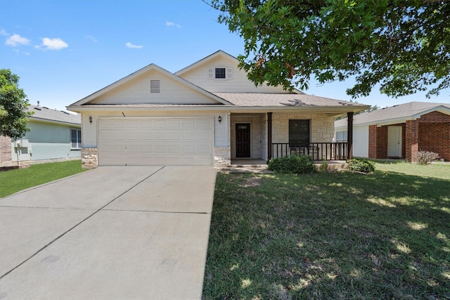 view of front of property featuring a porch, a garage, and a front yard