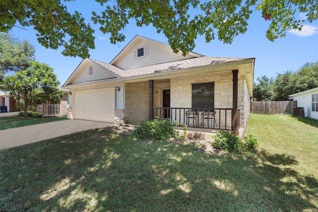 view of front of property with a front yard, a garage, and covered porch