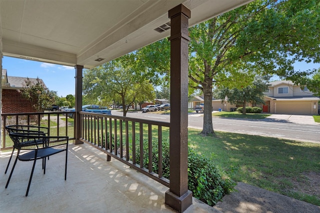 view of patio with a porch and a garage