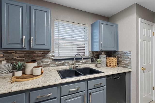 kitchen featuring sink, tasteful backsplash, light stone countertops, and dishwasher