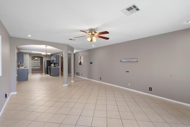 interior space with light tile patterned floors and ceiling fan with notable chandelier