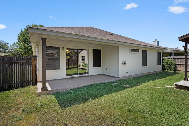 back of house featuring a patio area and a yard