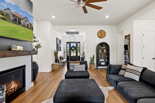 living room featuring ceiling fan and light hardwood / wood-style floors