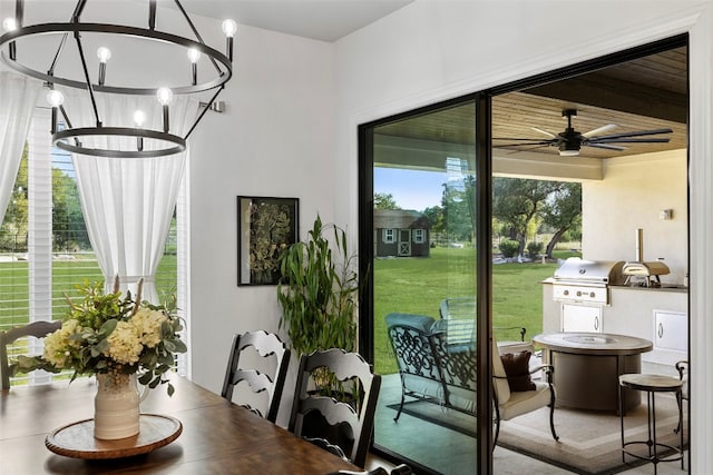 doorway with ceiling fan with notable chandelier