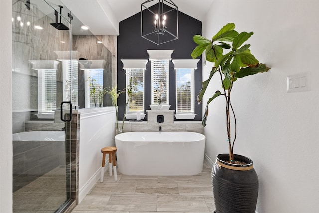 bathroom featuring vaulted ceiling, walk in shower, and tile walls