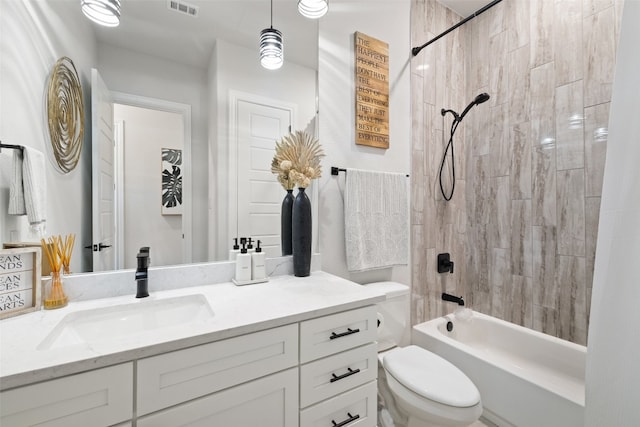 full bathroom featuring toilet, tiled shower / bath combo, and vanity