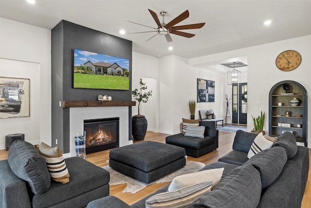 living room with ceiling fan and light wood-type flooring