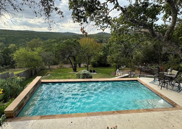 view of pool with a yard and a patio area