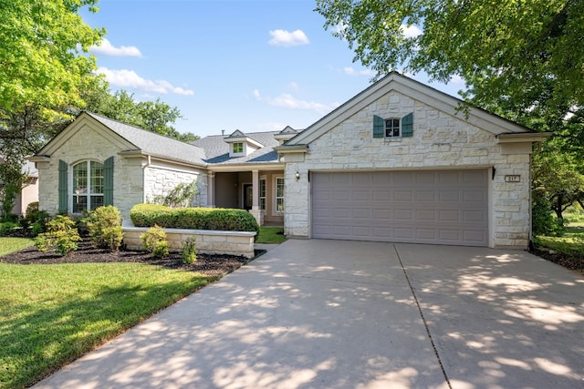 view of front of house with a front yard and a garage