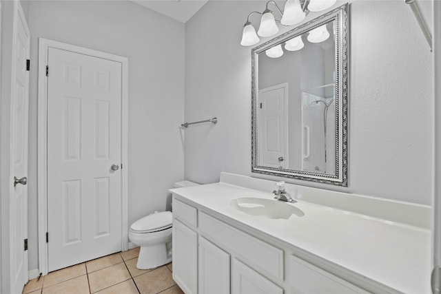 bathroom with tile patterned flooring, vanity, and toilet