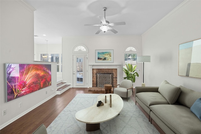 living room with crown molding, ceiling fan with notable chandelier, and hardwood / wood-style floors