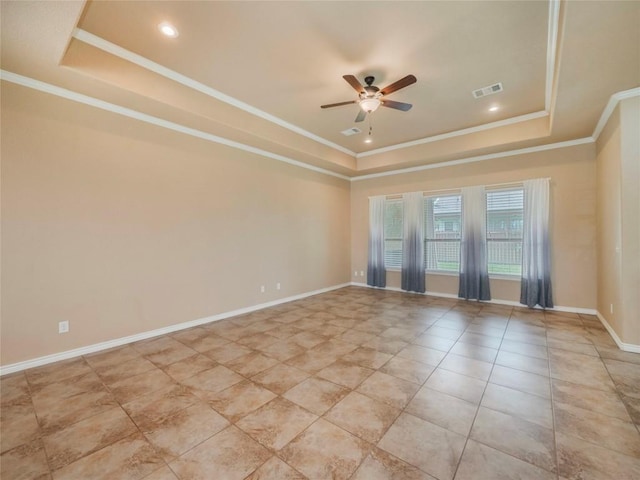 unfurnished room with crown molding, ceiling fan, a tray ceiling, and light tile patterned flooring