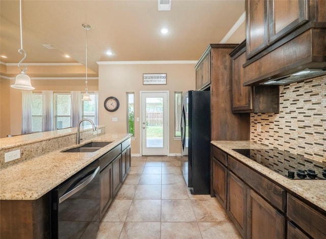 kitchen with sink, light stone counters, crown molding, hanging light fixtures, and black appliances