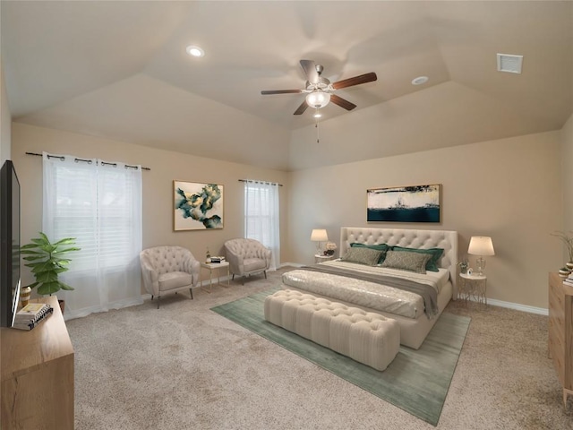 carpeted bedroom with vaulted ceiling, a raised ceiling, and ceiling fan