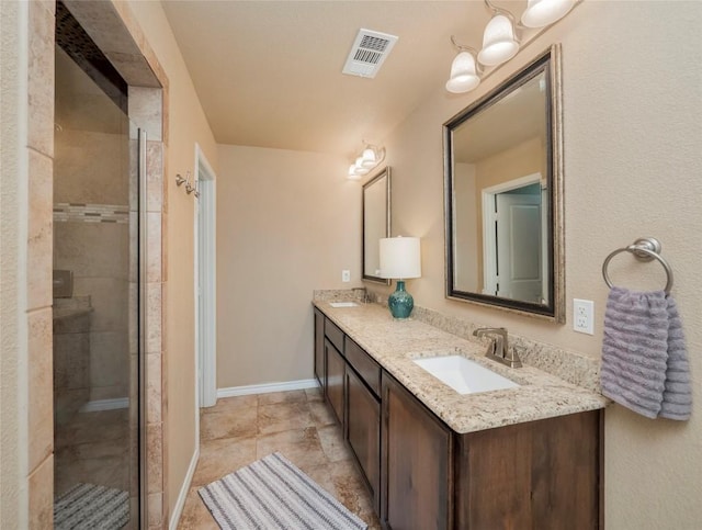 bathroom with a shower with door and vanity