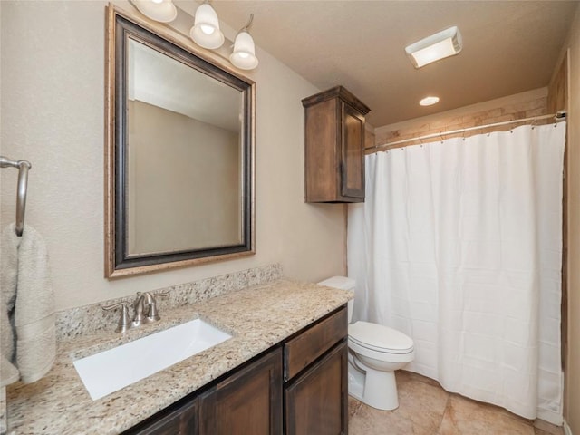 bathroom with vanity, curtained shower, tile patterned floors, and toilet