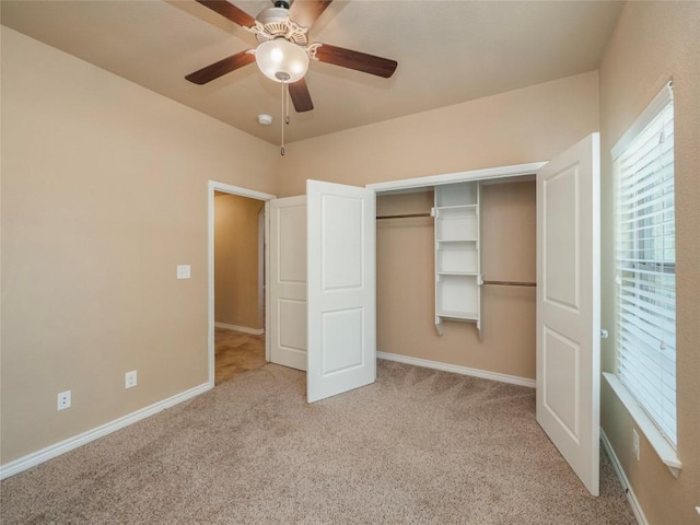 unfurnished bedroom with light carpet, ceiling fan, and a closet