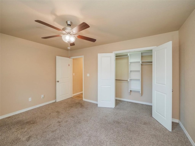 unfurnished bedroom with ceiling fan, light colored carpet, and a closet