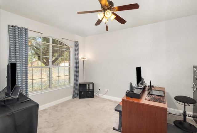 carpeted office space featuring ceiling fan