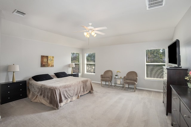 carpeted bedroom with ceiling fan and multiple windows