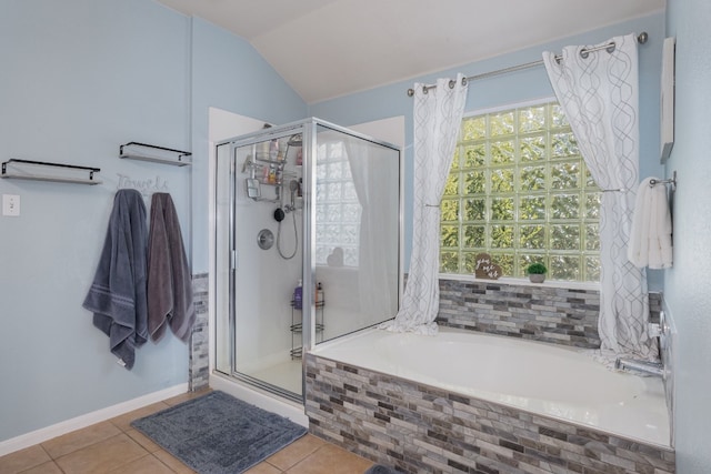 bathroom with tile patterned flooring, vaulted ceiling, and shower with separate bathtub